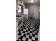 Kitchen with black and white checkered floor, white appliances, and ample counter space at 1181 Rocksprings St, Forest Park, GA 30297