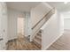 Carpeted staircase with neutral-toned walls and hardwood floors at 4171 Viola Pl, Atlanta, GA 30349