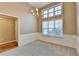 Bright dining room with wainscoting, chandelier, and hardwood floors at 468 Bradford Place Ln, Loganville, GA 30052