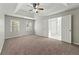 Main bedroom with carpet, ceiling fan and ensuite bath at 719 Oak Moss Dr, Lawrenceville, GA 30043