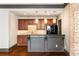 Basement bar with stone backsplash and dark cabinetry at 12695 Old Surrey Pl, Roswell, GA 30075