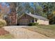 Tan three-car detached garage with a gravel driveway at 12695 Old Surrey Pl, Roswell, GA 30075