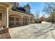 Three-car garage with arched entryway and long driveway at 12695 Old Surrey Pl, Roswell, GA 30075