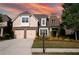 Two-story brick home with a three-car garage and landscaped yard at 6054 Brookhaven Cir, Duluth, GA 30097