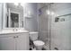 Clean bathroom with white vanity, marble shower, and a toilet at 6634 Pine Valley Trce, Stone Mountain, GA 30087