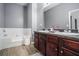 Main bathroom with a garden tub and double vanity at 6634 Pine Valley Trce, Stone Mountain, GA 30087