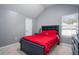 Bright bedroom with a red bedspread and built in shelving at 6634 Pine Valley Trce, Stone Mountain, GA 30087