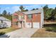 Two-story brick home with attached garage, driveway, and basketball hoop at 6634 Pine Valley Trce, Stone Mountain, GA 30087