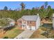 Two-story brick home with attached garage and basketball hoop, situated on a landscaped lot at 6634 Pine Valley Trce, Stone Mountain, GA 30087