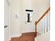 Bright entryway with hardwood floors, staircase, and door to the home at 2034 Nelms Pointe Lndg, Lawrenceville, GA 30043