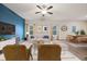 Living room with blue accent wall, wood floors, and view of the dining area at 3530 Ridge Hill Pkwy, Douglasville, GA 30135