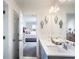 Shared bathroom with double vanity and view into bedroom at 7675 Homer Dr, Cumming, GA 30028