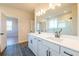 Elegant bathroom featuring a double vanity and a large mirror at 7675 Homer Dr, Cumming, GA 30028