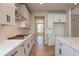 Modern kitchen with white cabinets, quartz countertops and stainless steel appliances at 7675 Homer Dr, Cumming, GA 30028