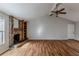 Living room with vaulted ceiling, stone fireplace, and wood flooring at 9887 Live Oak Ct, Douglasville, GA 30135