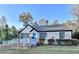 Charming ranch home with white brick exterior, gray roof, and blue front door at 2502 Tupelo Se St, Atlanta, GA 30317