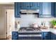 Stylish kitchen with blue cabinets, quartz countertops, and modern appliances at 361 Glenwood Se Ave, Atlanta, GA 30312