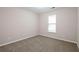 Well-lit bedroom with window and neutral decor at 1422 Sand Way, Lawrenceville, GA 30045