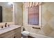 Powder room with diamond patterned walls and pedestal sink at 248 Fowler St, Woodstock, GA 30188