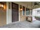 Front door and porch with stone flooring and a porch swing at 248 Fowler St, Woodstock, GA 30188