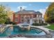 Brick house with a large pool and patio in the backyard at 2195 Lake Shore Lndg, Alpharetta, GA 30005