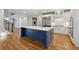 Bright kitchen featuring a blue island, stainless steel appliances, and hardwood floors at 2195 Lake Shore Lndg, Alpharetta, GA 30005