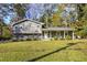 Gray house with white trim, front porch, and landscaped lawn at 4246 Antler Se Trl, Smyrna, GA 30082