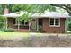 Brick ranch house with a spacious yard and mature trees at 5621 Zanola Sw Dr, Mableton, GA 30126