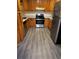 Kitchen features wood cabinets, granite counters and gray vinyl flooring at 5621 Zanola Sw Dr, Mableton, GA 30126