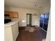 Eat-in kitchen with damaged flooring and access to a back deck at 5750 Old Carriage Dr, Atlanta, GA 30349