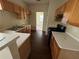 Galley kitchen with wood cabinets and linoleum countertops at 5750 Old Carriage Dr, Atlanta, GA 30349