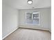 Bright bedroom with neutral walls and carpet, featuring a large window with a view at 982 Huntsman Trce, Lawrenceville, GA 30045