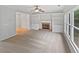 Bright living room features a fireplace, built-in shelving, and hardwood floors at 982 Huntsman Trce, Lawrenceville, GA 30045