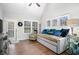 Bright sunroom with daybed, hardwood floors, and access to backyard at 141 Legends Way, Hiram, GA 30141