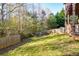 Spacious backyard with a wooden fence, providing a private and wooded setting at 138 Slippery Rock Ct, Villa Rica, GA 30180