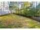 Large backyard with sloped terrain and wooded area at 138 Slippery Rock Ct, Villa Rica, GA 30180