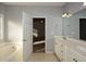 Double vanity bathroom with garden tub and view of bedroom at 138 Slippery Rock Ct, Villa Rica, GA 30180