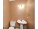 Small half bathroom with pedestal sink at 138 Slippery Rock Ct, Villa Rica, GA 30180