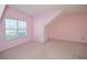 Pink bedroom with a window, built-in storage, and neutral carpeting at 138 Slippery Rock Ct, Villa Rica, GA 30180