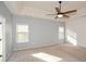 Bright bedroom with gray walls, a ceiling fan, and a stylish shiplap accent wall at 138 Slippery Rock Ct, Villa Rica, GA 30180