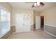 Spacious bedroom with double doors, ceiling fan, and window blinds at 138 Slippery Rock Ct, Villa Rica, GA 30180