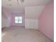 Pink bedroom with a window, built-in storage, and neutral carpeting at 138 Slippery Rock Ct, Villa Rica, GA 30180