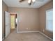 Spacious bedroom with neutral walls and carpet, featuring a ceiling fan and an ensuite bathroom at 138 Slippery Rock Ct, Villa Rica, GA 30180