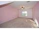 Charming bedroom with pink walls and carpet, large window and a ceiling fan at 138 Slippery Rock Ct, Villa Rica, GA 30180