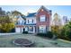 Two-story brick home with three-car garage and landscaped lawn at 138 Slippery Rock Ct, Villa Rica, GA 30180