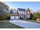 Two-story brick home with three-car garage and landscaped lawn at 138 Slippery Rock Ct, Villa Rica, GA 30180