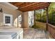 Relax on this deck featuring a hot tub and wooded backdrop at 138 Slippery Rock Ct, Villa Rica, GA 30180
