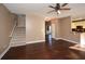 Hardwood floor living room with staircase and kitchen views at 138 Slippery Rock Ct, Villa Rica, GA 30180