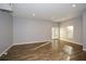 Sunlit living room with hardwood floors and French doors at 138 Slippery Rock Ct, Villa Rica, GA 30180