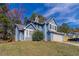 Two-story house, blue siding, attached garage, and a well-manicured lawn at 6016 King Way Walk, Lithonia, GA 30058